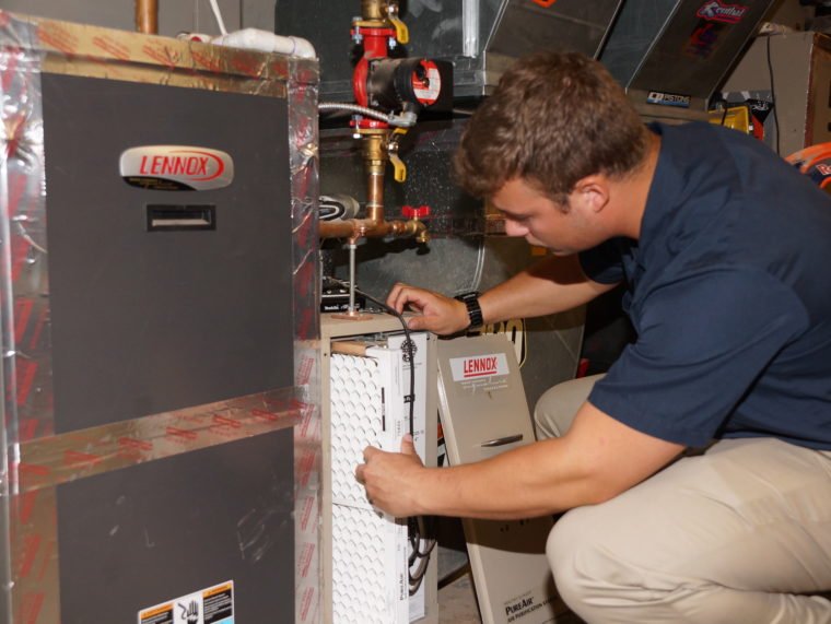 HVAC Unit Being Serviced By a Technician